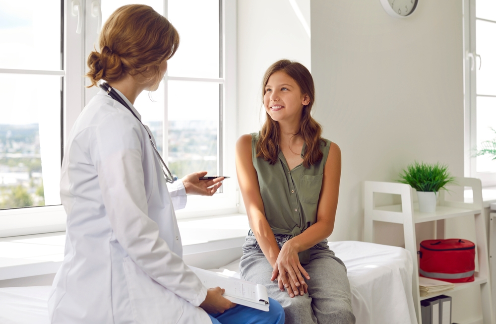 Happy,Teenage,Girl,Is,Listening,To,Doctor,During,Medical,Examination