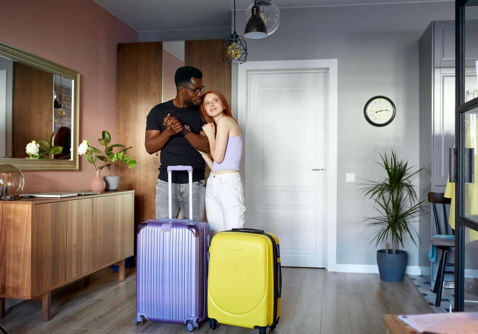 cheerful-interracial-couple-enter-new-apartment